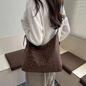 Vintage leopard print hobo bag worn by model, large capacity crossbody tote handbag