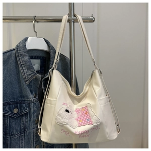 Close-up of cute cartoon puppy embroidery and Happy Puppy text on white tote bag