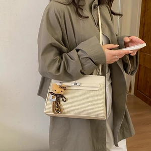 Chic woven crossbody bag with cream leather trim and gold twist lock closure