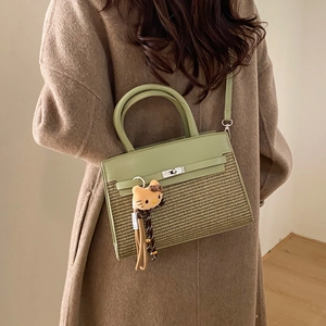 Green leather and woven straw square handbag with top handle and crossbody strap