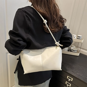 Minimalist white faux leather shoulder bag with golden zipper and knotted strap design