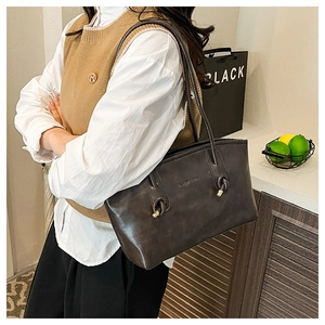Detail of vintage brown leather tote bag with knot strap and Fashion Bags text logo