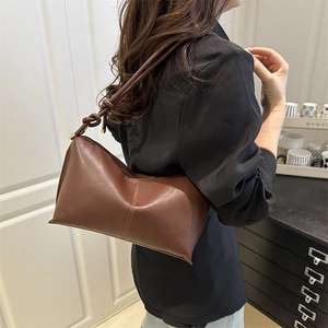 Minimalist deep brown soft leather underarm bag with decorative knot shoulder strap