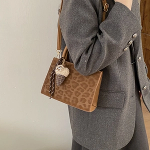 Fashionable leopard print crossbody tote bag with a cute plush ice cream keychain accessory