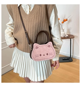 Sac à bandoulière rose en forme de chat avec poignées marron dans un décor minimaliste