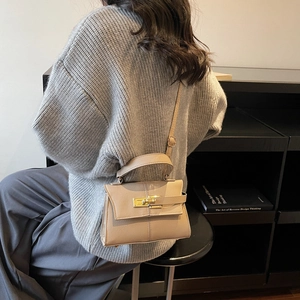 Mini beige top handle crossbody bag with gold lock buckle and lychee texture