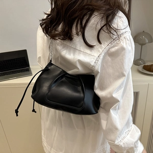 Elegante borsa a spalla nera in ecopelle con tracolla a catena indossata da modella