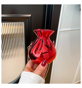 Detail of red metallic lucky bag mini bag with gold chain strap in hand display