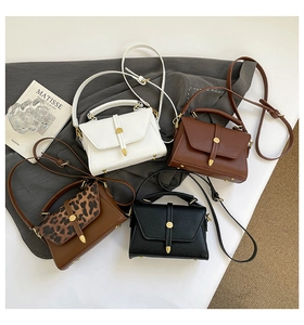 Detailed view of four elegant crossbody bags in leather with leopard print and solid colors