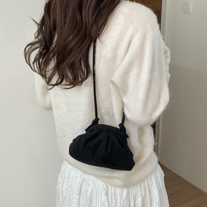 Minimalist black pleated bucket bag with thin shoulder strap for casual crossbody wear