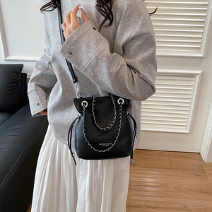 Fashionable black faux leather bucket bag with silver chain strap and drawstring closure