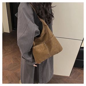 Detail view of brown suede tote bag featuring white contrast stitching and large capacity