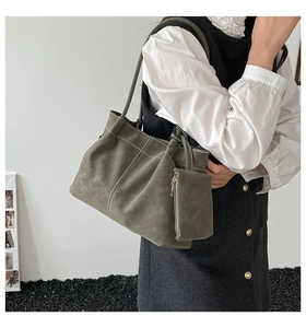 Detail of olive green tote bag featuring white contrast stitching and matching side pouch