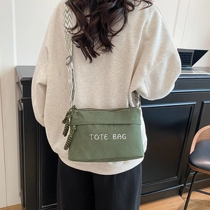 Olive green corduroy tote bag with TOTE BAG embroidery and woven shoulder strap