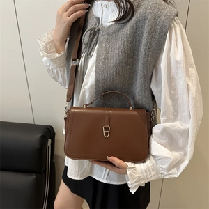 Elegant brown baguette shoulder bag with adjustable strap and vintage gold buckle hardware