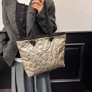 Champagne gold star-quilted tote bag with black braided rope handles for women
