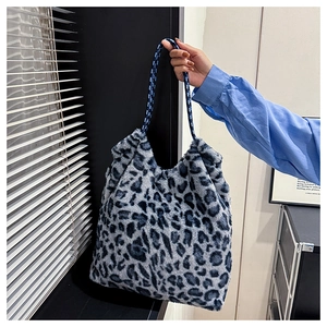 Macro view of blue leopard faux fur tote bag with thick blue and white braided rope handles