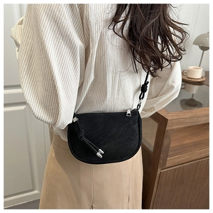Detail of black leather half-moon crossbody bag with knot strap and embossed logo