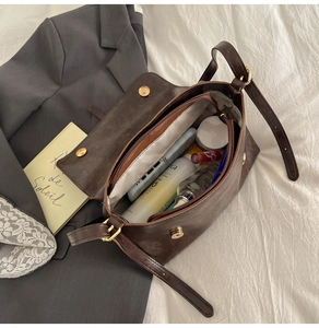Internal view showing multiple compartments of the vintage brown leather crossbody bag