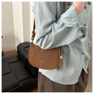 Brown faux suede saddle bag with knotted strap detail and metallic zipper closure