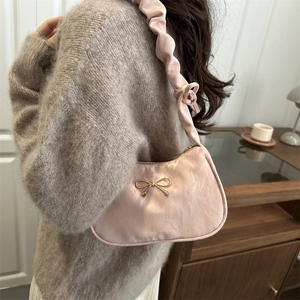 Borsa sottobraccio rosa a pieghe con fiocco dorato e tracolla arricciata elegante