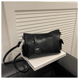 Detail view of the black faux leather commuter tote bag with fashion hanging tag