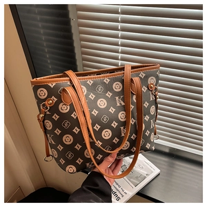 Detail of vintage monogram tote bag in dark brown canvas with leather handles