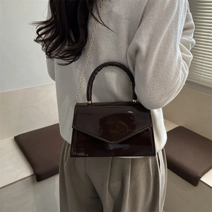 Trendy dark brown patent leather crossbody handbag with gold chain strap and envelope flap