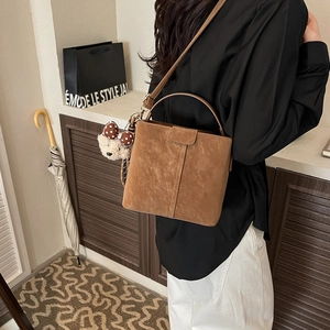 Braune gefrostete Beuteltasche mit Griff, Riemen und Bärenanhänger im Streetstyle-Look