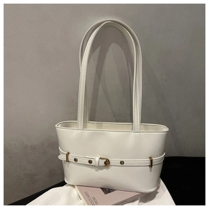 Close-up of white PU leather tote bag with vintage gold buckle belt and soft texture