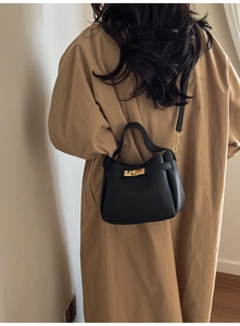 Chic black litchi pattern bucket bag styled with a khaki coat showing side details
