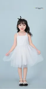 Detail of white tulle beach dress for girls featuring delicate lace and thin straps