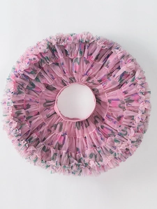 Pink fluffy girl's tutu skirt with green floral prints and layered tulle fabric