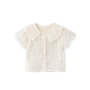 Close-up of white girls' short sleeve shirt with ruffled texture and doll collar