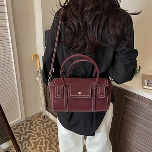 Vintage burgundy square handbag with contrast stitching and adjustable shoulder strap