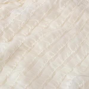 Detailed macro shot of white pleated vertical ruffles on toddler girl's tutu skirt set