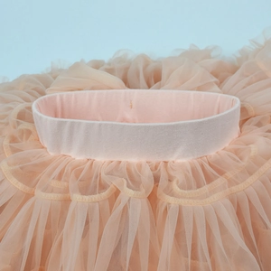 Detailed view of elastic waistband and layered mesh tulle on pink baby tutu skirt