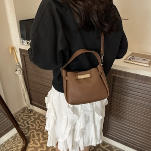 Brown lychee-grain leather crossbody bucket bag with golden metal turn-lock closure