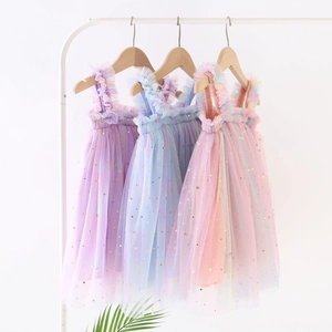 Close-up of three rainbow tulle dresses with sparkling star and moon gold foil prints