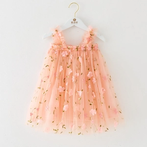 Detail of multi-layer pink tulle dress featuring floral 3D embroidery and ruffled straps