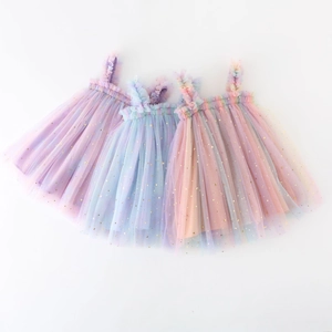 Detail of rainbow tulle layers featuring golden star and moon sequins on girl's tutu dress