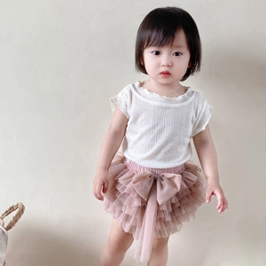 Detail of baby girl tutu set featuring a ribbed white top and layered pink mesh skirt