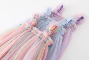 Detail of sequin star patterns on gradient rainbow mesh fabric for girls' tutu dress