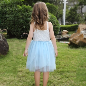 Close-up of girls' white floral lace bodice and layered light blue tulle mesh skirt detail
