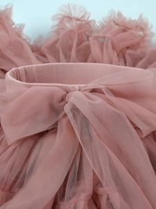 Pink multi-layer tutu skirt for girls featuring an elastic waistband and large bow decoration