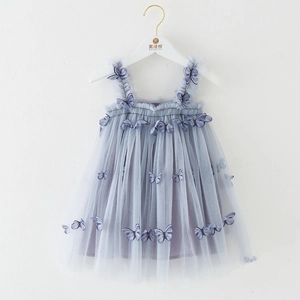 Detail of light blue tulle girl's dress with delicate 3D butterfly embroidery and ruffles