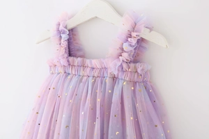 Close-up of rainbow mesh tulle and gold star sequins on girls princess dress