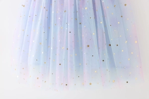 Detail of sequin stars and moon patterns on gradient rainbow mesh tulle girls' dress