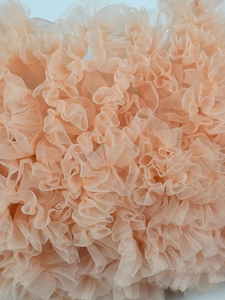 Layered apricot tulle tutu skirt with dense ruffles and soft mesh texture detail
