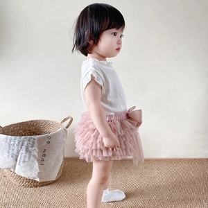 Detail of baby girl tutu skirt with pink layered mesh tulle and ruffled white shirt collar
